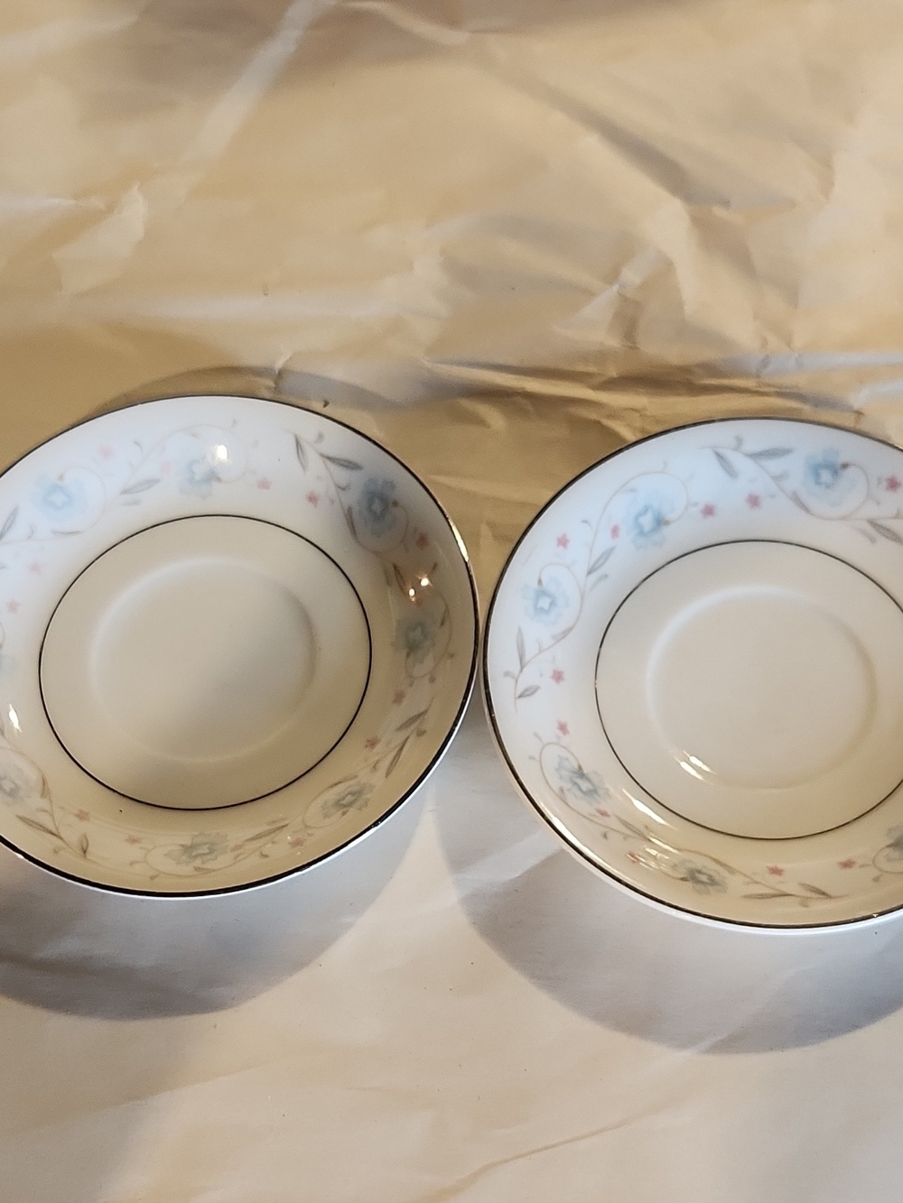 Elegant White Porcelain Saucer Set with Soft Blue and Pink Floral Trim